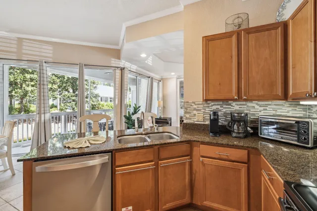 a kitchen with stainless steel appliances granite countertop a sink a stove and a microwave