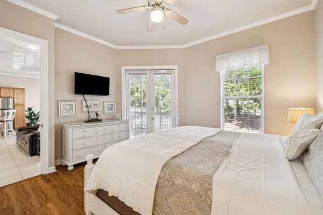 a bedroom with a large bed and a flat screen tv