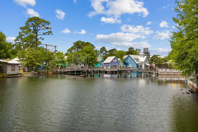 a view of an ocean with boats and trees in the background