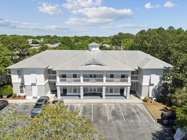 a aerial view of a house with a swimming pool and a yard