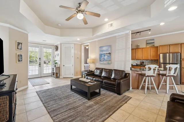 a living room with furniture a flat screen tv and a window