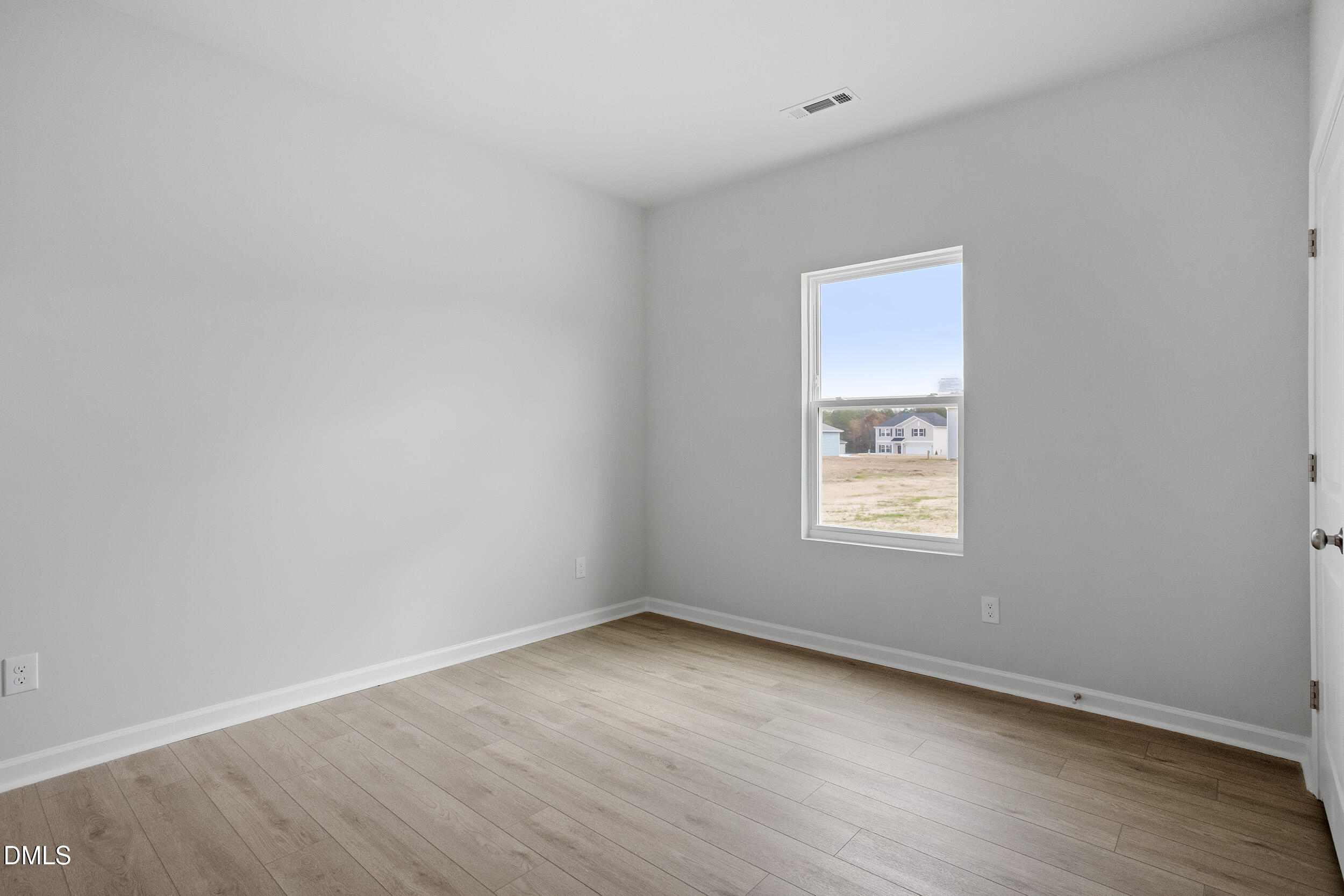 79 Osgood Street Angier, NC 27501 - Photo 17 of 31 an empty room with wooden floor and windows
