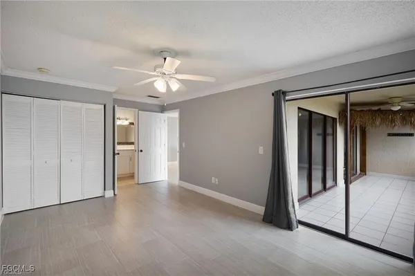 a view of a big room with closet and chandelier fan