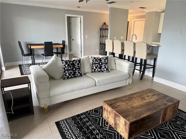 a kitchen with kitchen island a dining table and chairs
