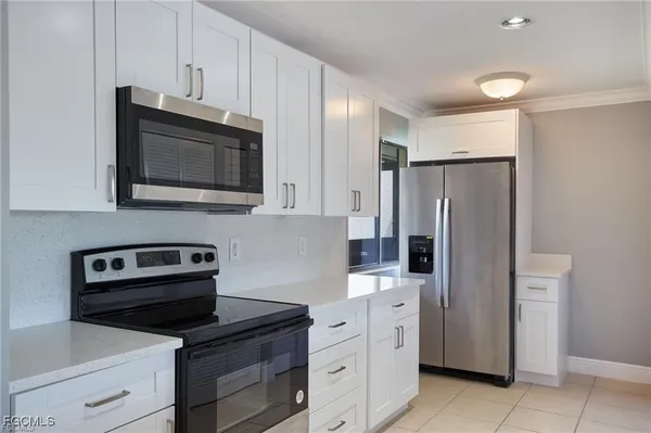 a kitchen with stainless steel appliances a stove microwave and refrigerator