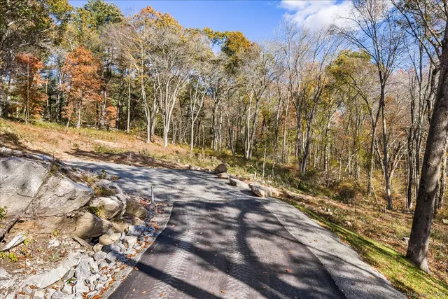 a view of a yard with wooden fence