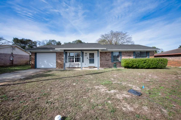 a front view of a house with a garden