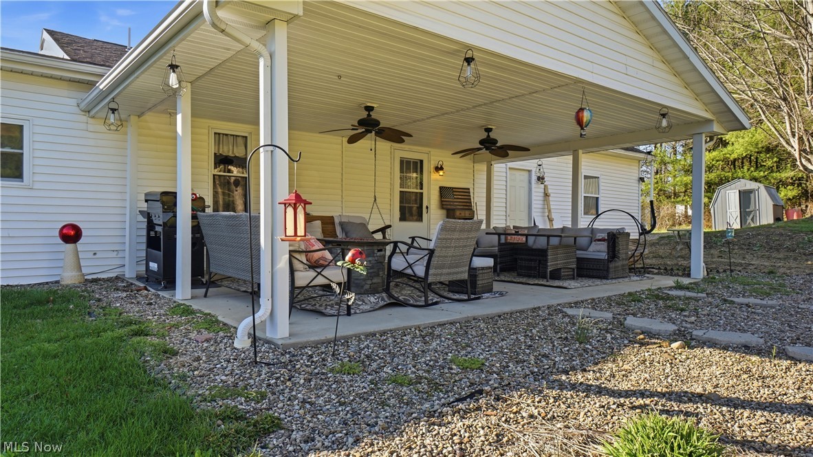 65892 Endley Road Cambridge, OH 43725 - Photo 47 of 50 View of patio / terrace with outdoor seating, ceiling fan, area for grilling, and a storage unit