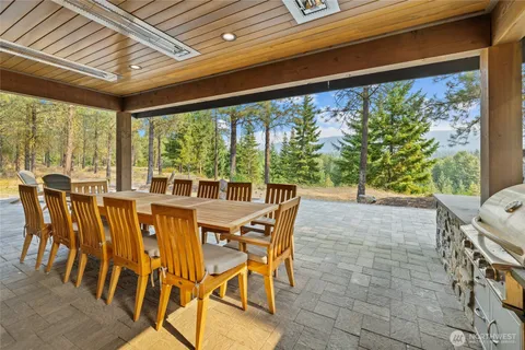 a dining room with furniture and a floor to ceiling window
