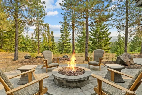 a view of a patio with table and chairs and a barbeque with potted plants