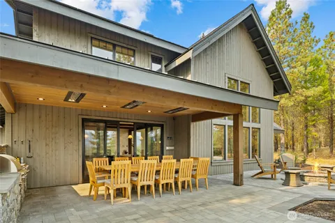 a view of a patio with table and chairs and a barbeque