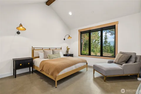 a bedroom with a bed and window