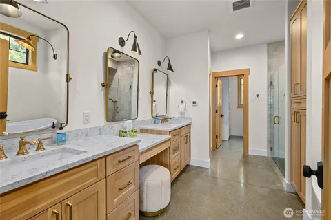 a spacious bathroom with a granite countertop sink mirror and a shower
