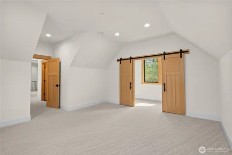 an empty room with closet and a bathroom