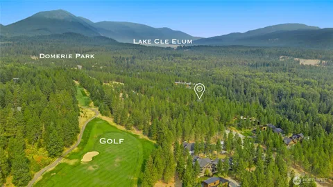 a view of a lush green hillside and a building
