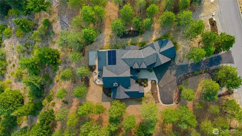 an aerial view of a house with pool yard and outdoor seating