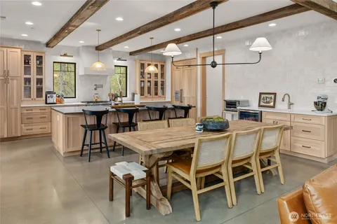 a dining room with a table chairs and a wooden floor