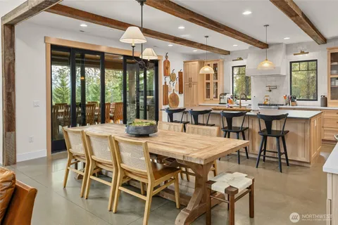 a dining room with furniture a chandelier and wooden floor