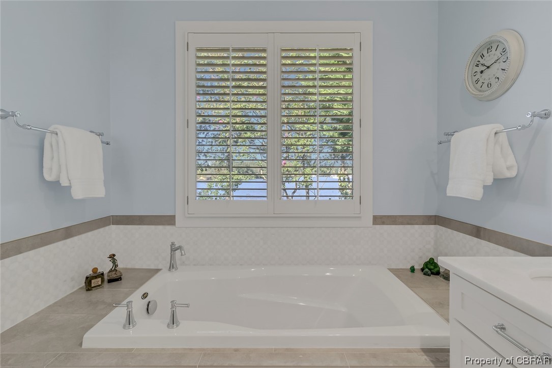 192 Bayberry Point Lane Kilmarnock, VA 22482 - Photo 38 of 49 Bathroom featuring a bathing tub, a healthy amount of sunlight, and vanity