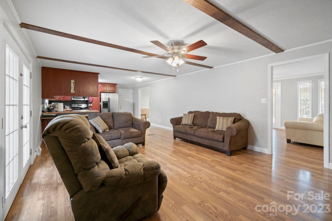 2656 Sandy Ford Road Newton, NC 28658 - Photo 11 of 34 a living room with furniture a ceiling fan and a rug