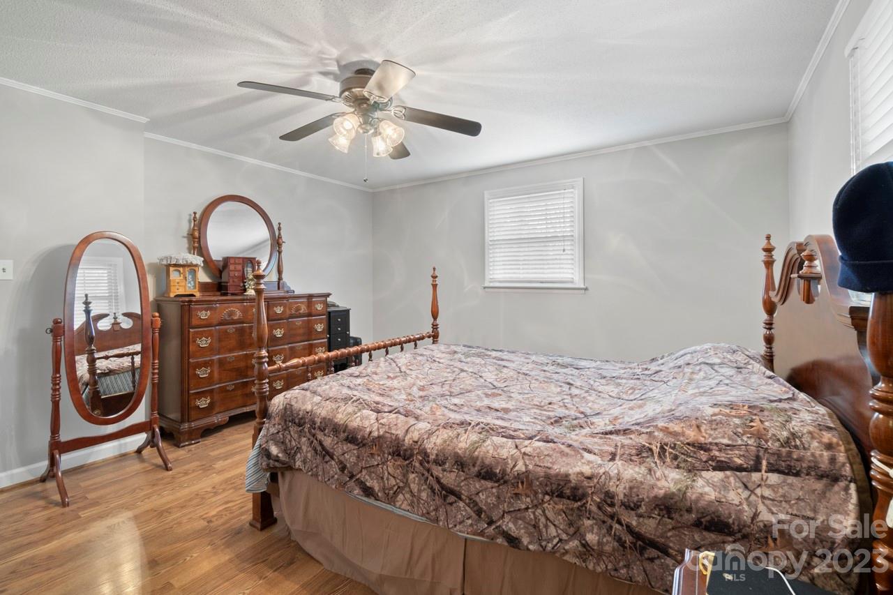 2656 Sandy Ford Road Newton, NC 28658 - Photo 16 of 34 a bedroom with a bed and a chandelier