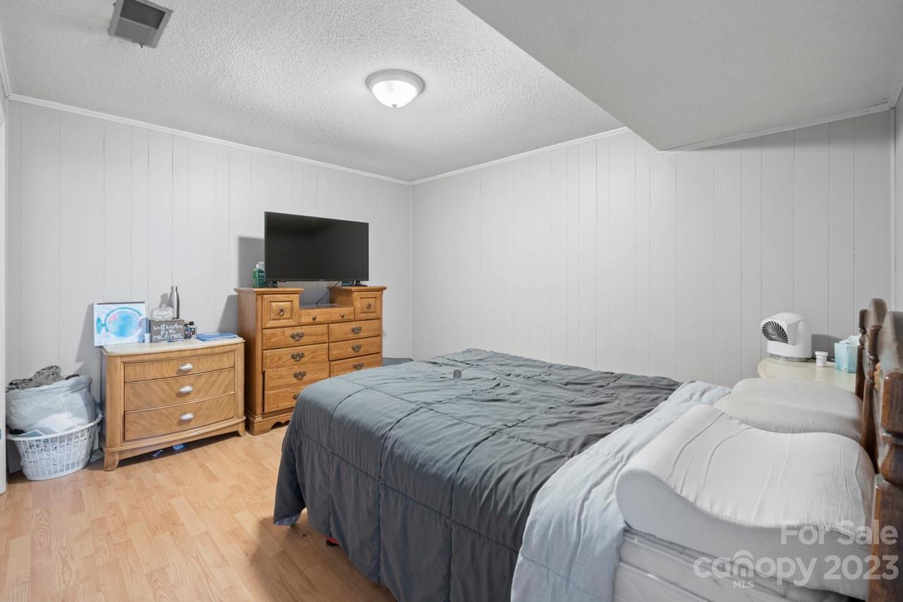 2656 Sandy Ford Road Newton, NC 28658 - Photo 24 of 34 a bedroom with a bed and a flat screen tv
