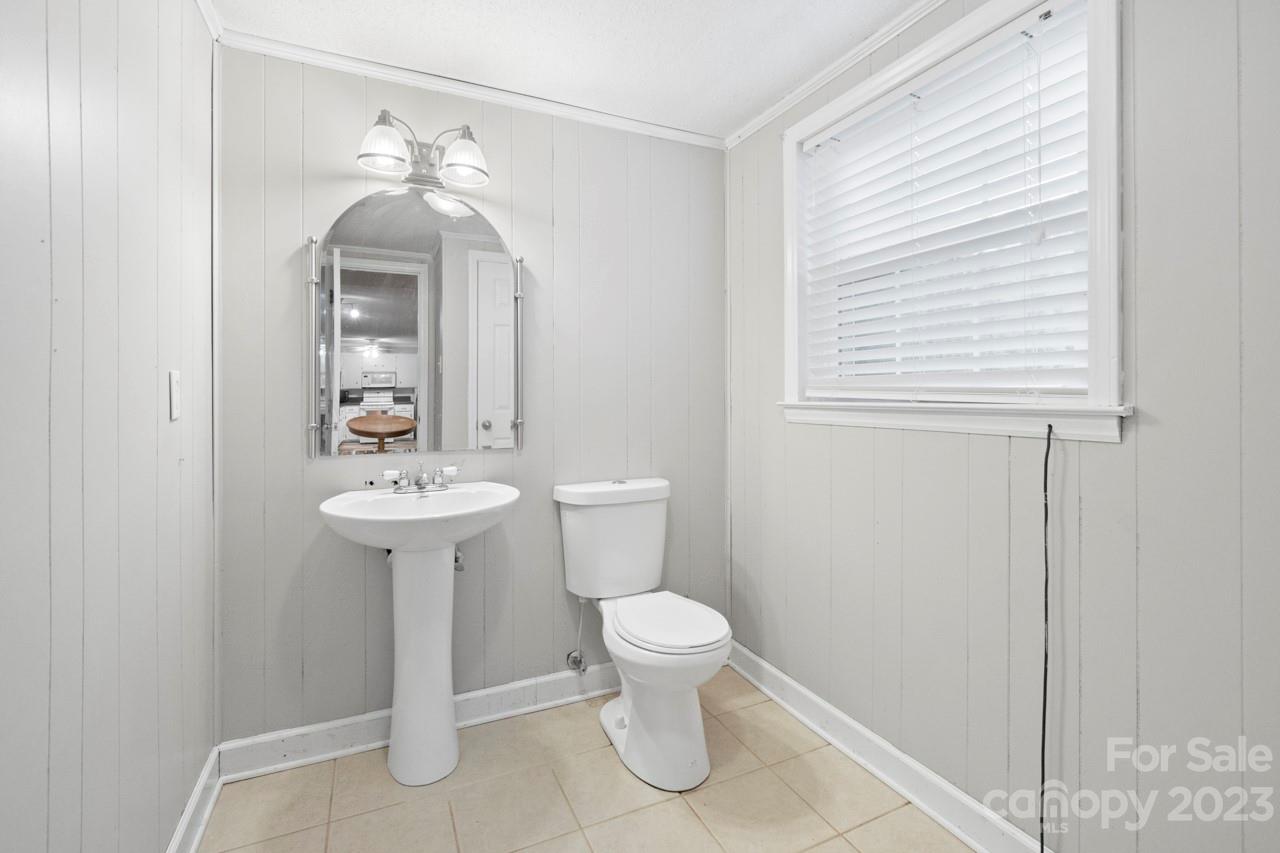 2656 Sandy Ford Road Newton, NC 28658 - Photo 25 of 34 a bathroom with a sink toilet and mirror