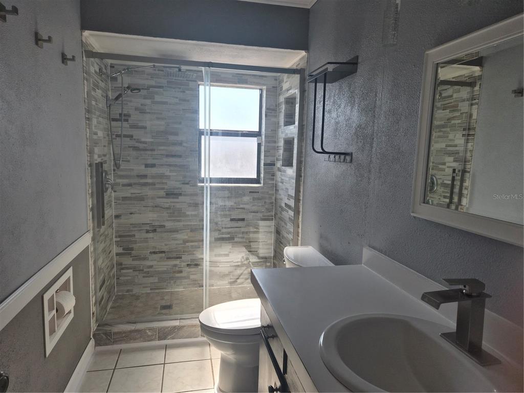 1080 Leeward Road Venice, FL 34293 - Photo 12 of 33 a bathroom with a sink a toilet and shower