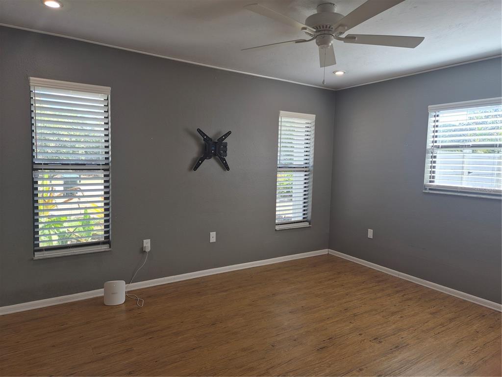 1080 Leeward Road Venice, FL 34293 - Photo 13 of 33 a view of an empty room with a window and wooden floor