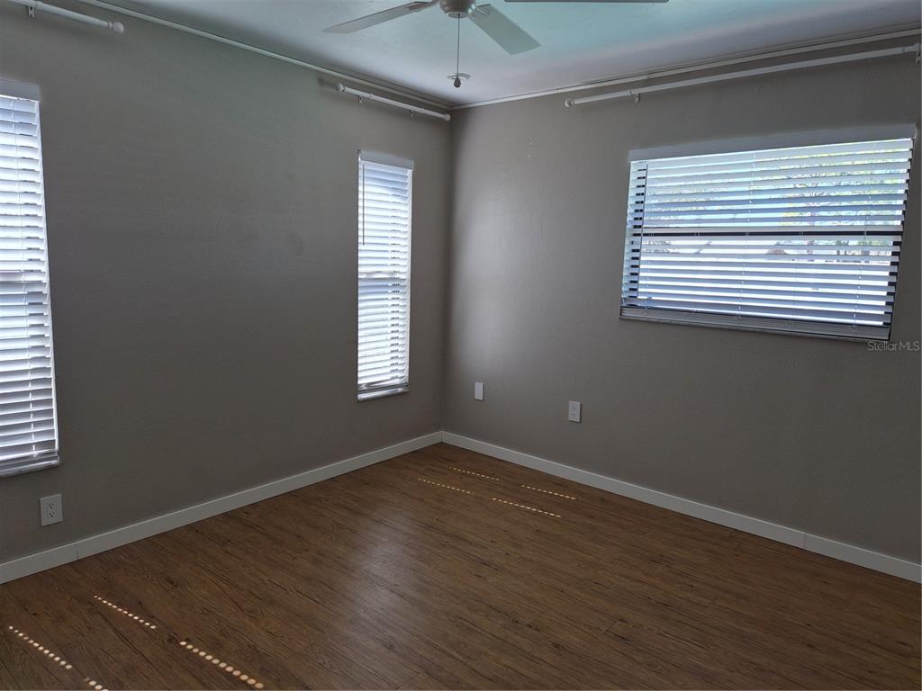 1080 Leeward Road Venice, FL 34293 - Photo 16 of 33 an empty room with wooden floor and windows