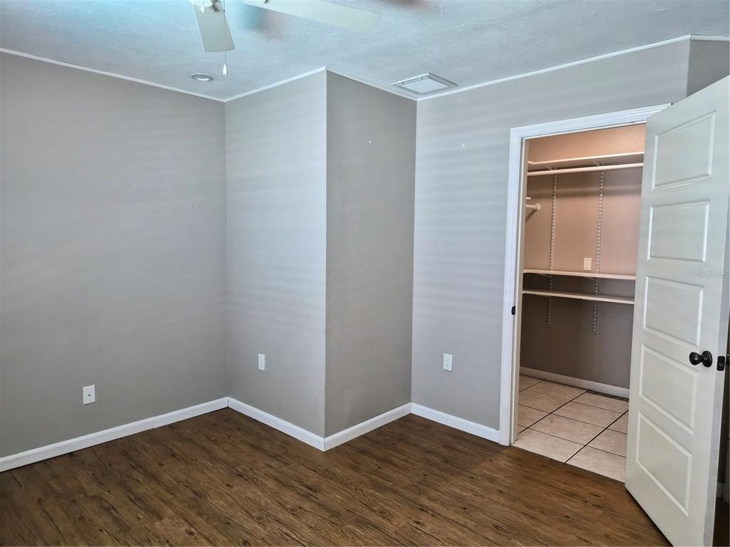1080 Leeward Road Venice, FL 34293 - Photo 18 of 33 an empty room with wooden floor and closet