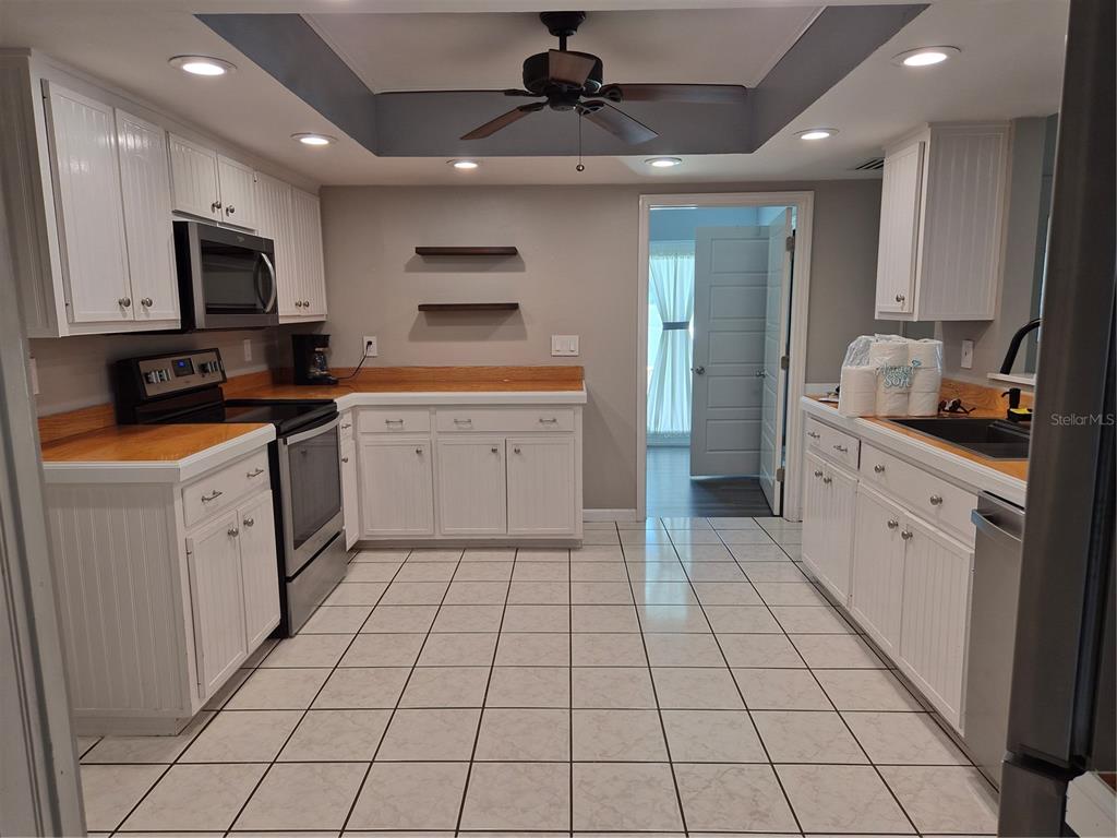 1080 Leeward Road Venice, FL 34293 - Photo 8 of 33 a kitchen with stainless steel appliances a sink cabinets and microwave