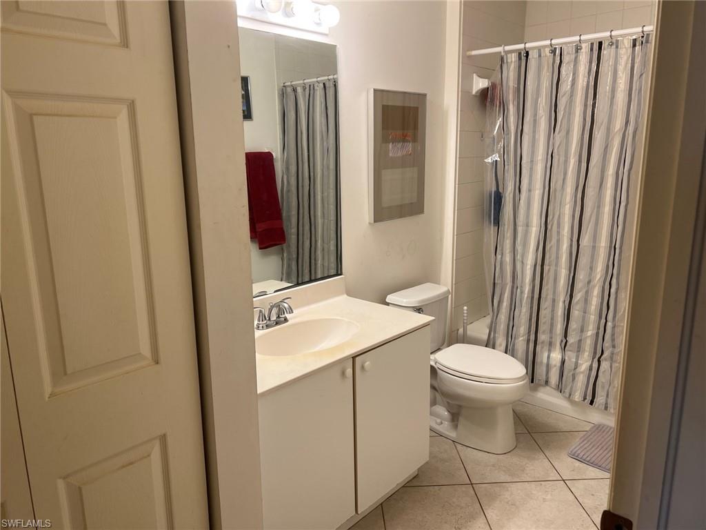 1220 Sarah Jean Circle, Unit L103 Naples, FL 34110 - Photo 12 of 23 a bathroom with a sink and a mirror