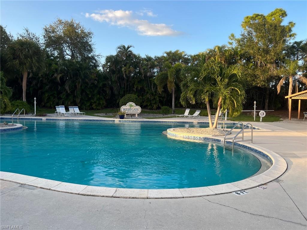 1220 Sarah Jean Circle, Unit L103 Naples, FL 34110 - Photo 13 of 23 a view of outdoor space yard and swimming pool