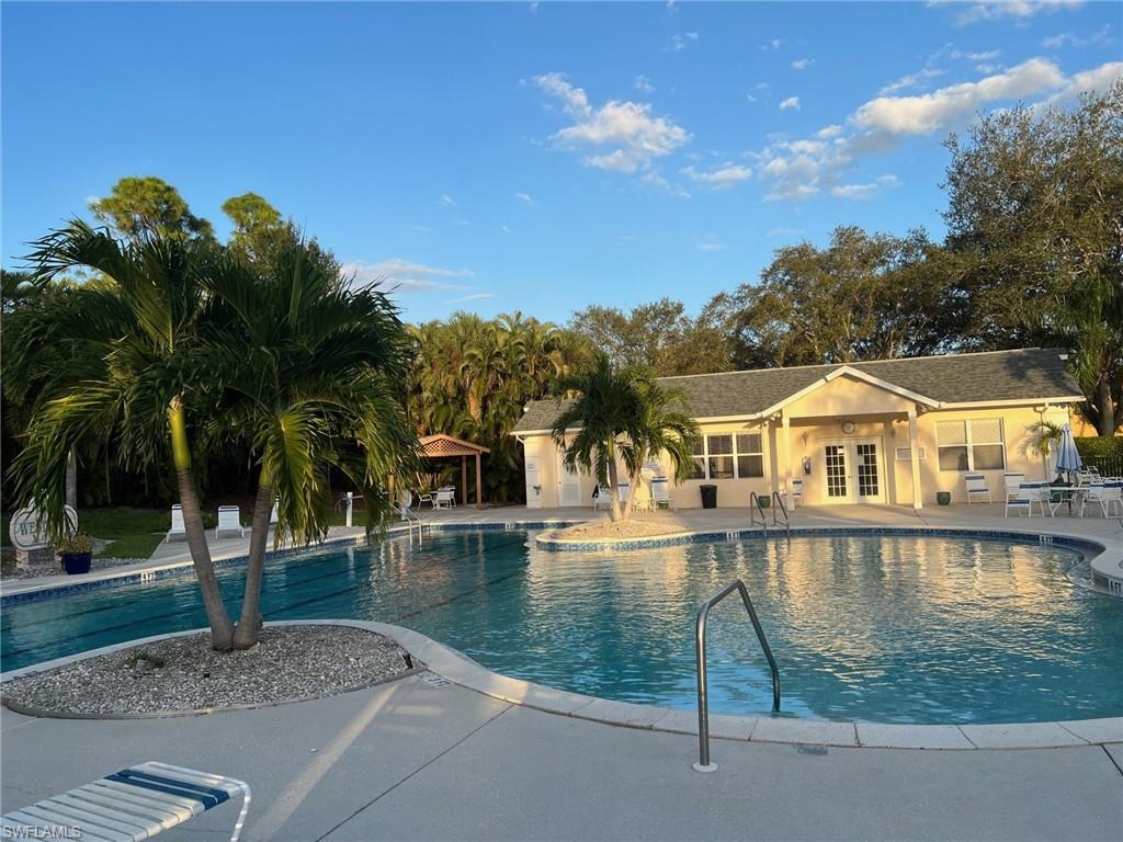 1220 Sarah Jean Circle, Unit L103 Naples, FL 34110 - Photo 14 of 23 a view of a lake with a house