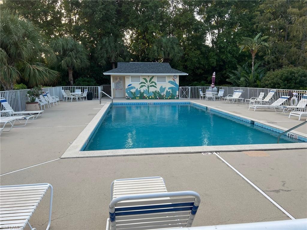 1220 Sarah Jean Circle, Unit L103 Naples, FL 34110 - Photo 15 of 23 a view of a swimming pool with a patio