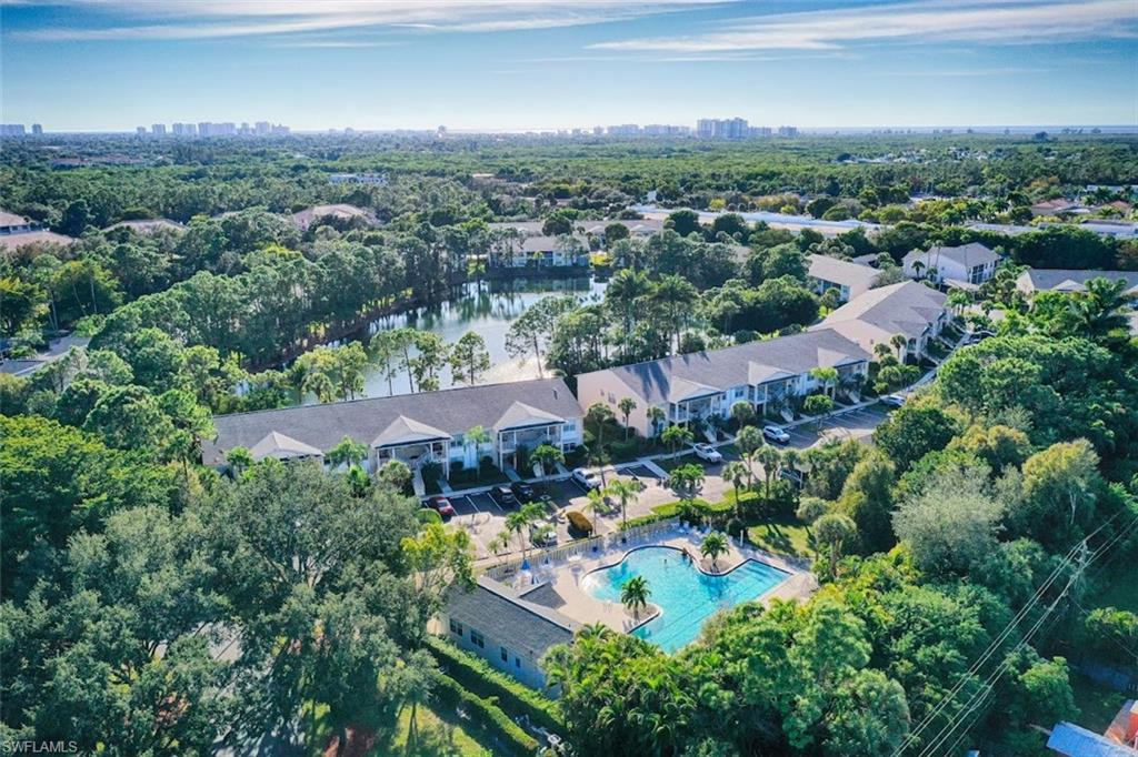 1220 Sarah Jean Circle, Unit L103 Naples, FL 34110 - Photo 20 of 23 an aerial view of residential houses with outdoor space and trees