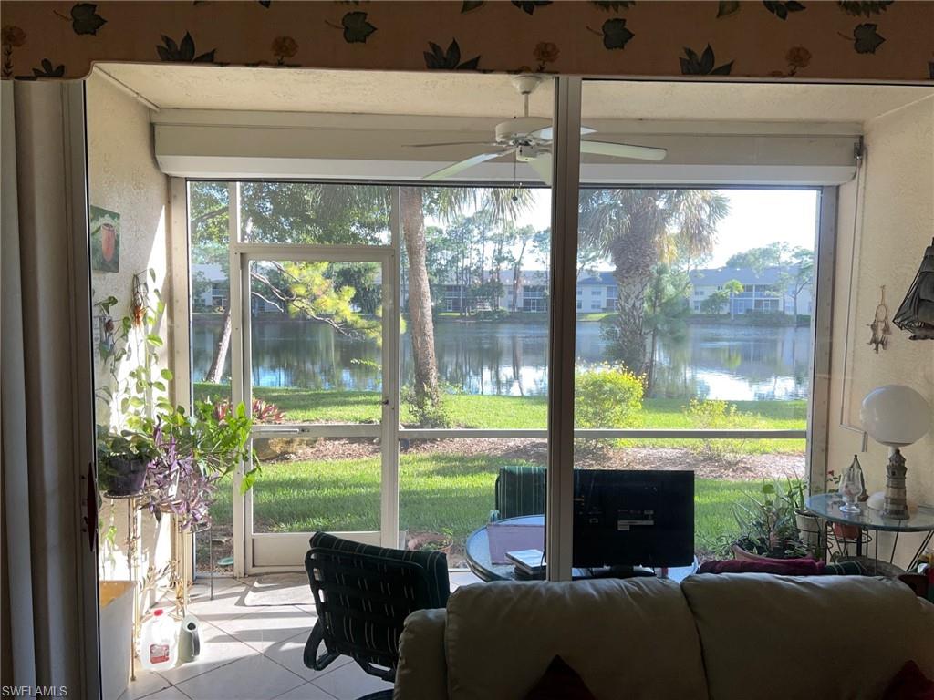 1220 Sarah Jean Circle, Unit L103 Naples, FL 34110 - Photo 2 of 23 a room with furniture and a floor to ceiling window
