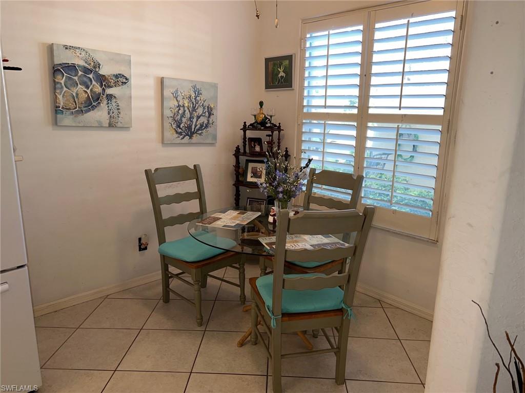 1220 Sarah Jean Circle, Unit L103 Naples, FL 34110 - Photo 6 of 23 a view of a dining room with furniture and window