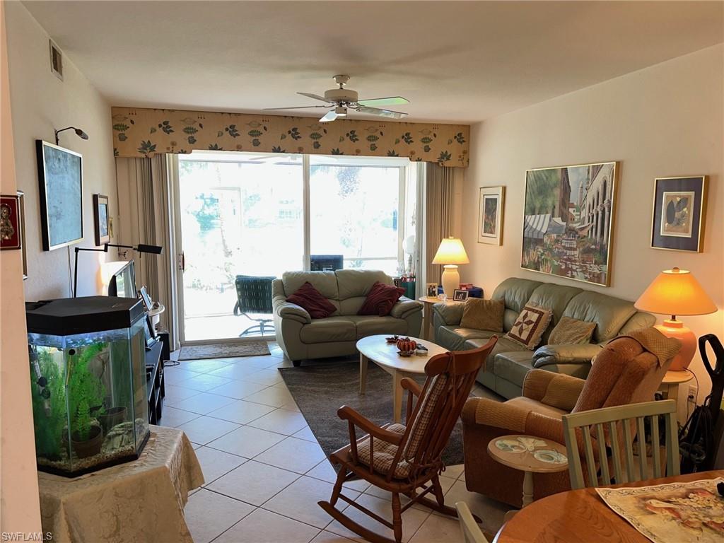 1220 Sarah Jean Circle, Unit L103 Naples, FL 34110 - Photo 7 of 23 a living room with furniture and a large window