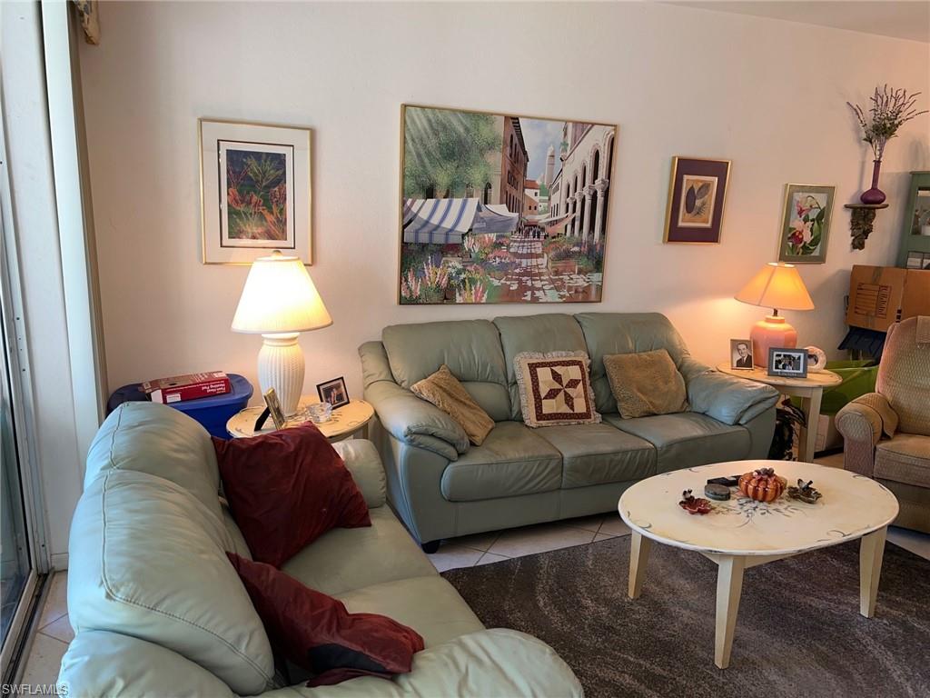 1220 Sarah Jean Circle, Unit L103 Naples, FL 34110 - Photo 8 of 23 a living room with furniture and a table