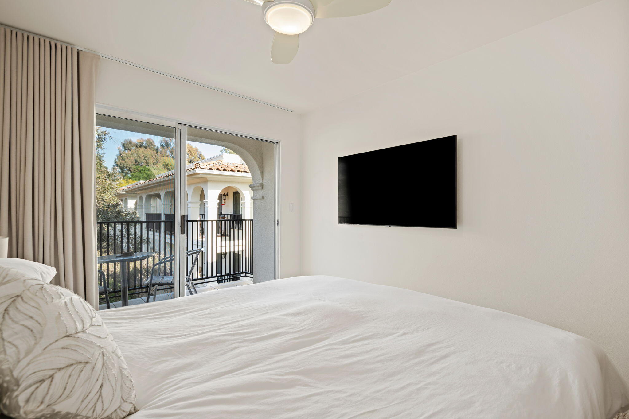 269 Por La Mar Circle Santa Barbara, CA 93103 - Photo 17 of 26 a bedroom with a bed and a flat tv screen next to a window