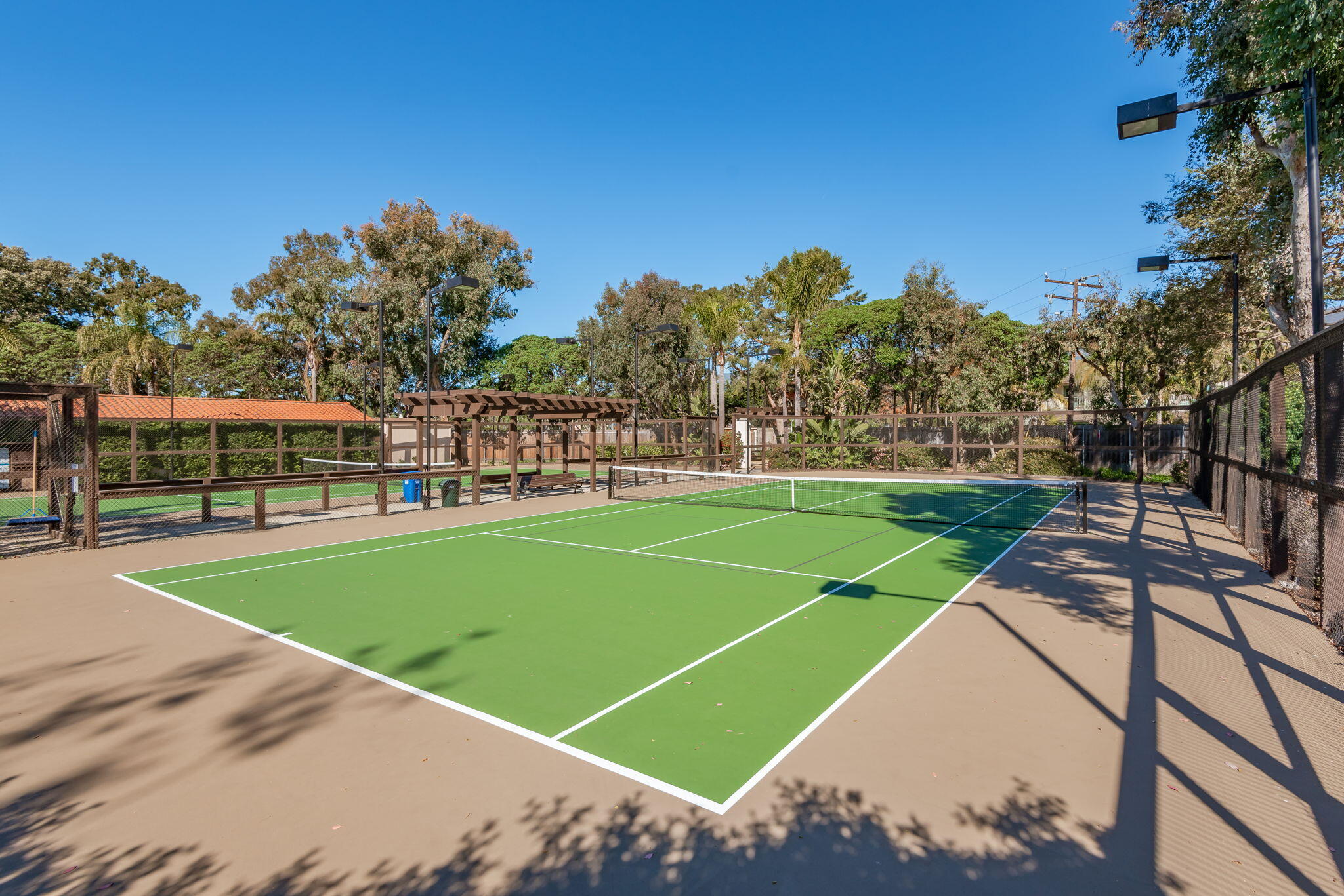 269 Por La Mar Circle Santa Barbara, CA 93103 - Photo 23 of 26 a view of a tennis ground with large trees