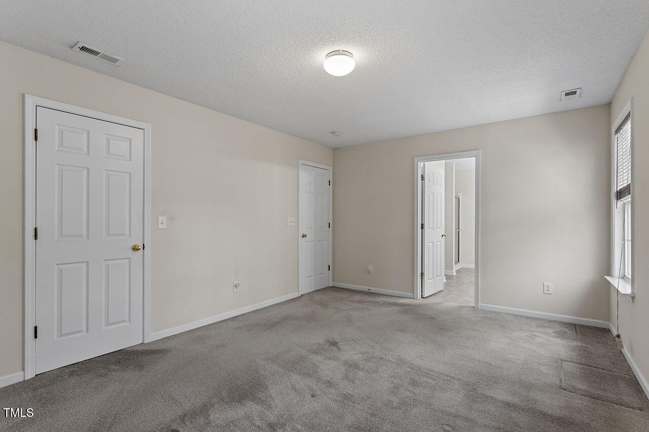 110 Caley Road Apex, NC 27502 - Photo 13 of 28 Primary Bedroom with Walk-In Closet