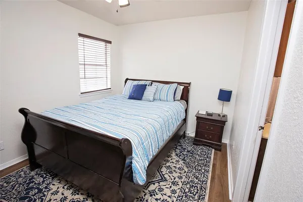 a bedroom with a bed closet and a window