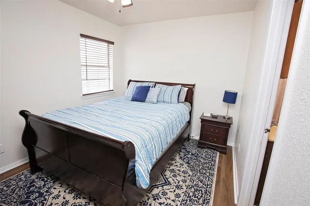 a bedroom with a bed closet and a window