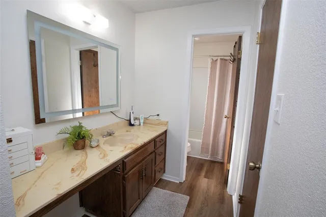 a bathroom with a granite countertop sink and a mirror