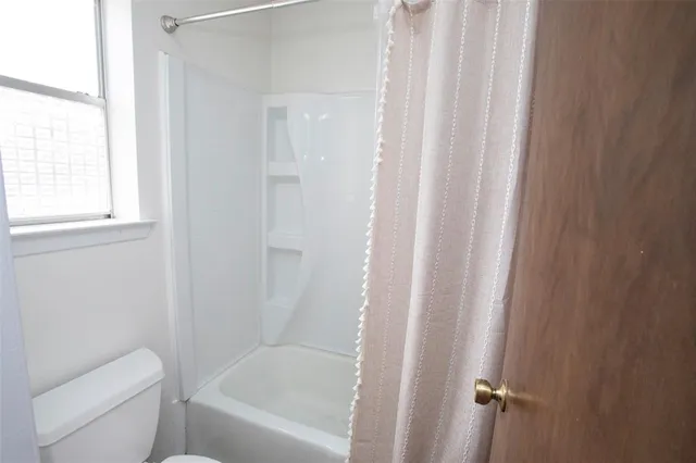 a bathroom with a bathtub and shower