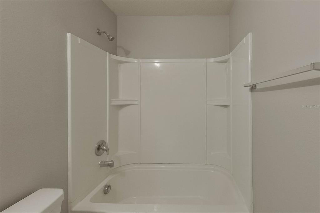 1709 Nebraska Loop Sumterville, FL 33585 - Photo 14 of 22 a bathroom with a bathtub and a shower