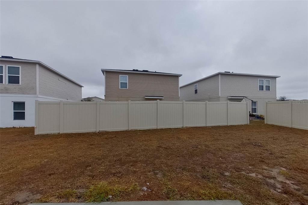 1709 Nebraska Loop Sumterville, FL 33585 - Photo 21 of 22 a view of a house with backyard and garage